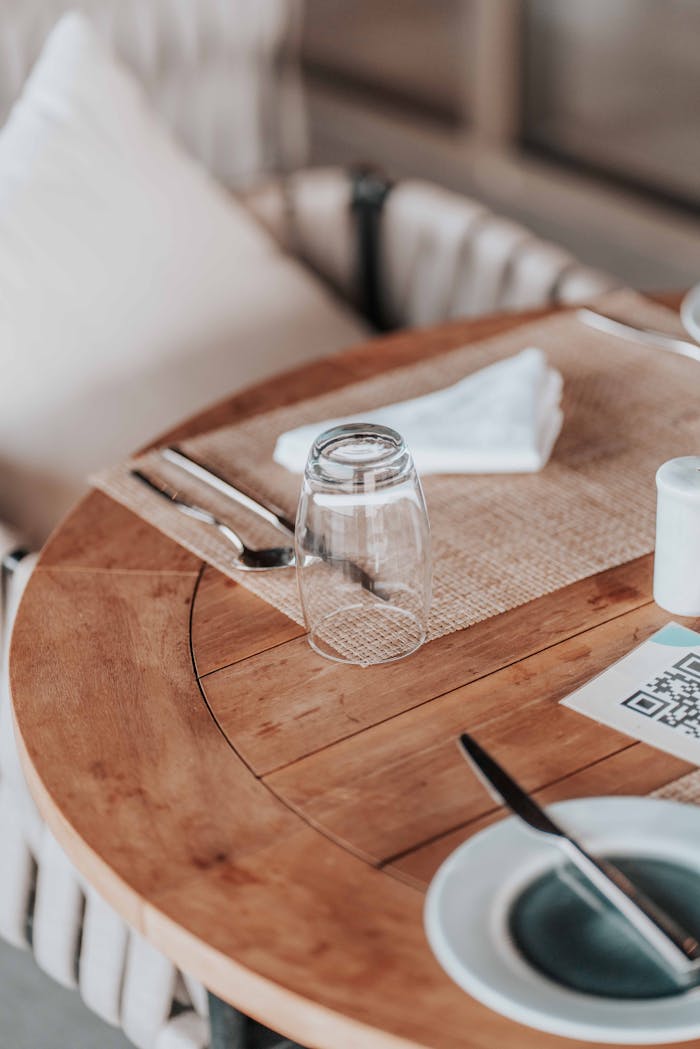 A High Angle Shot of Prepared Wooden Table in Restaurant